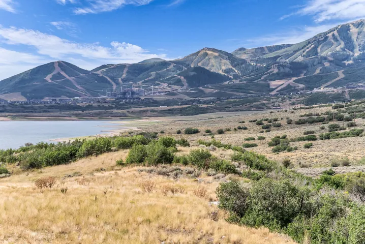 Expansive terrain featuring natural vegetation and a prominent body of water