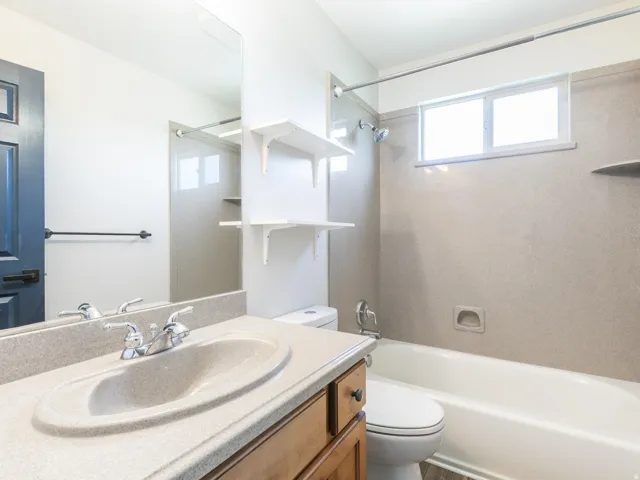 Full guest bath on upper level with solid surface, easy care tub surround.