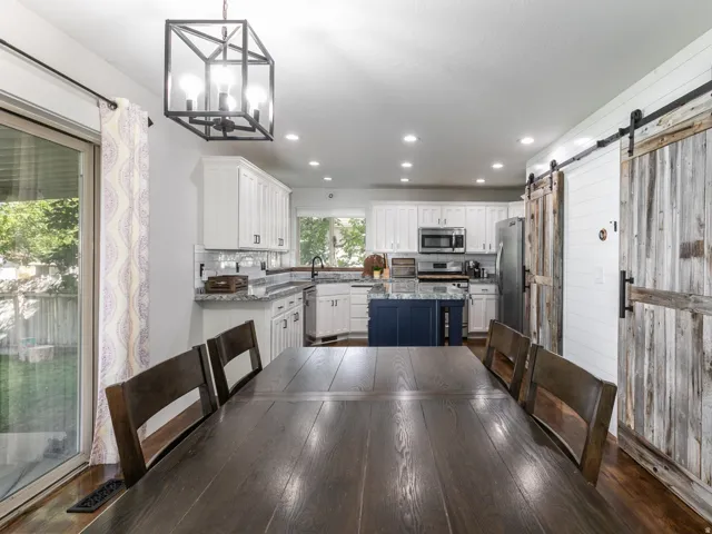 Open-concept dining and kitchen area with recessed lighting