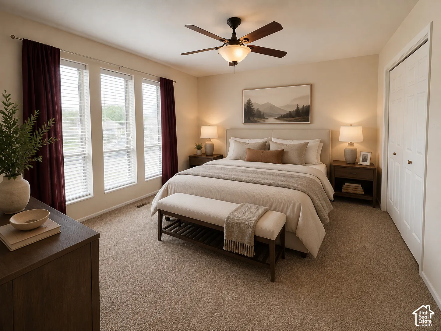 Plush carpeted flooring, a ceiling fan with integrated lighting, and a closet with bifold doors