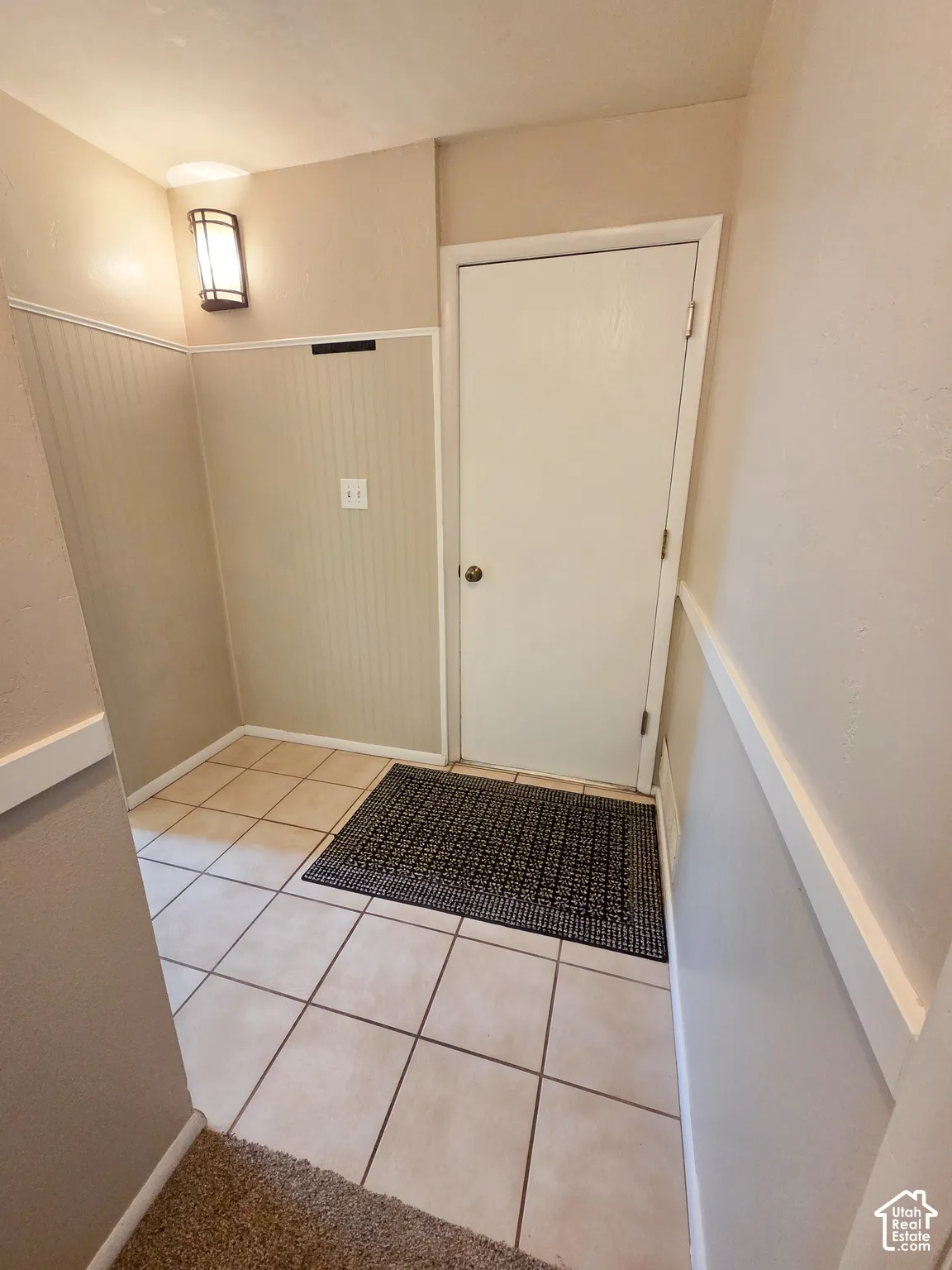 Tiled entry flooring with beadboard wall paneling