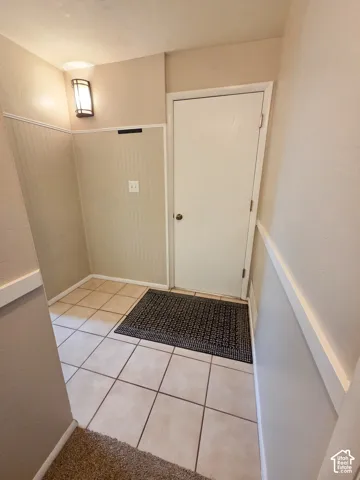 Tiled entry flooring with beadboard wall paneling