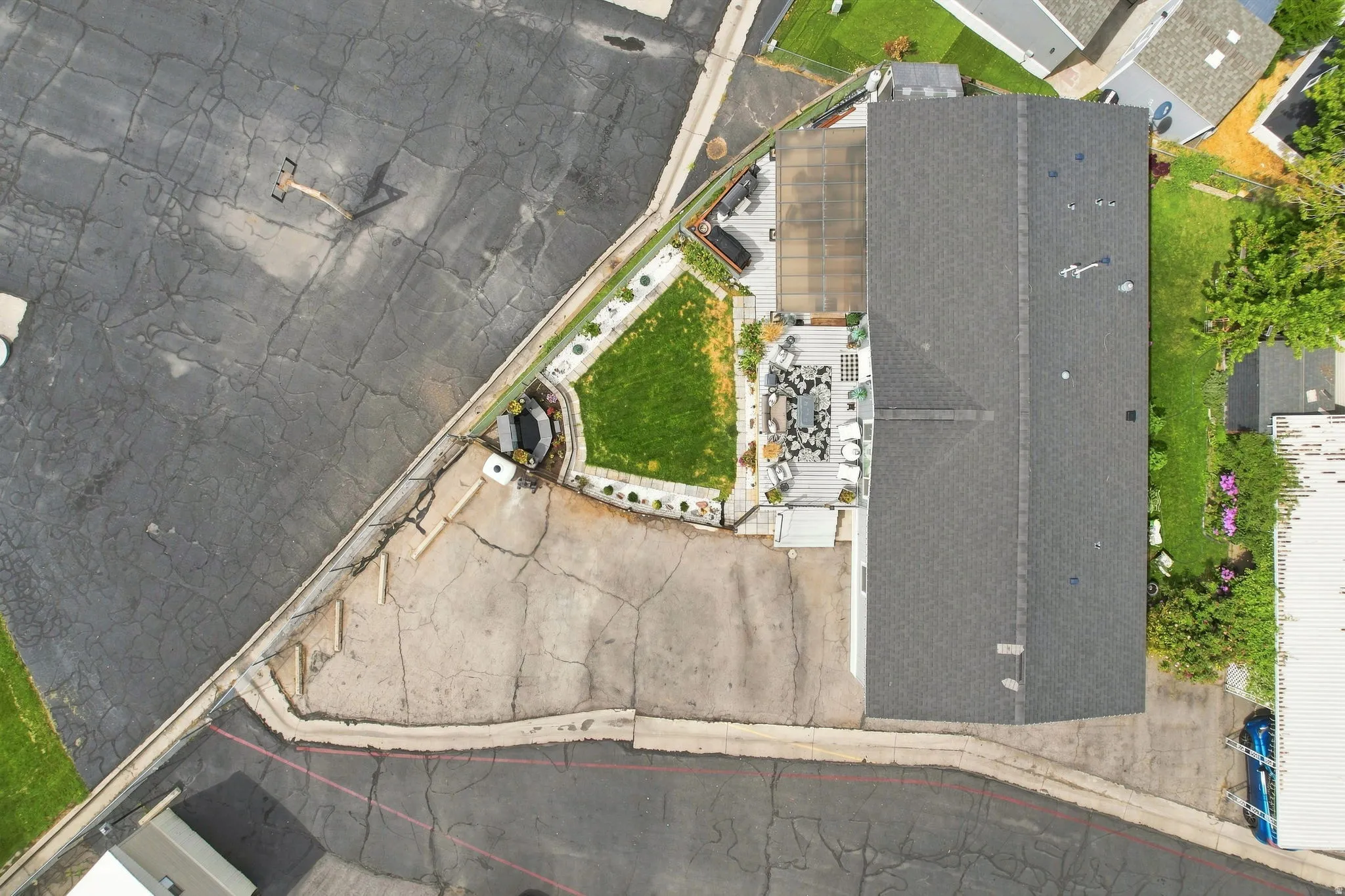 Expansive paved outdoor area with integrated landscaping and a dedicated lawn space