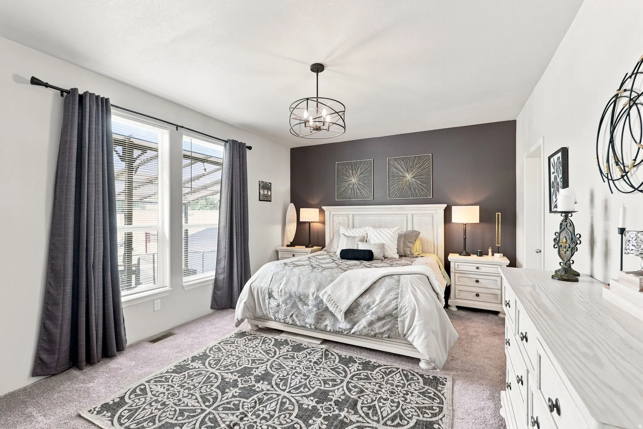 Recessed windows with blinds, carpeted flooring, a dark accent wall, and a ceiling-mounted light fixture