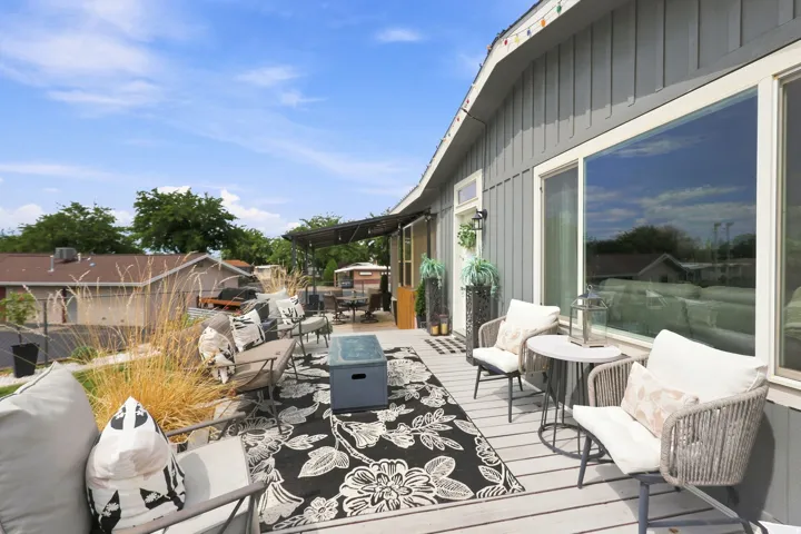 Expansive outdoor deck featuring composite decking, vertical siding, and large windows