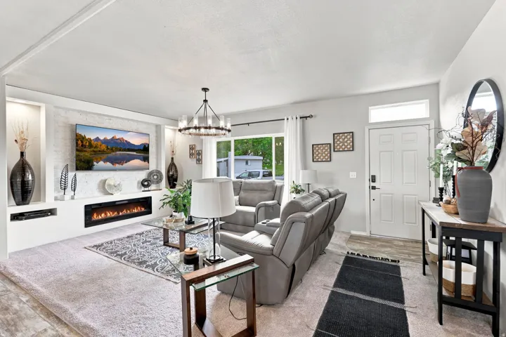 Built-in media center with an electric fireplace, recessed niches, and a textured accent wall