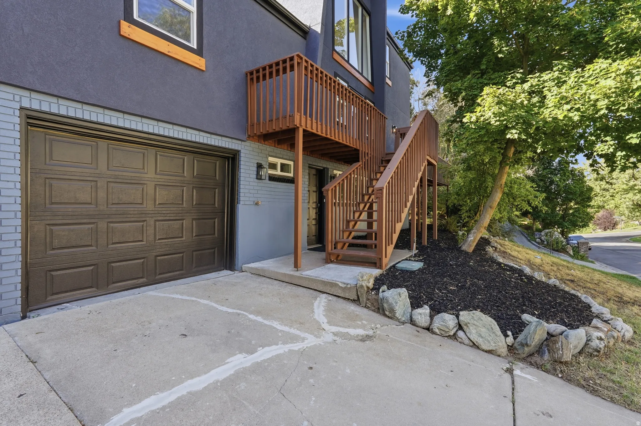 Concrete driveway with a paneled garage door