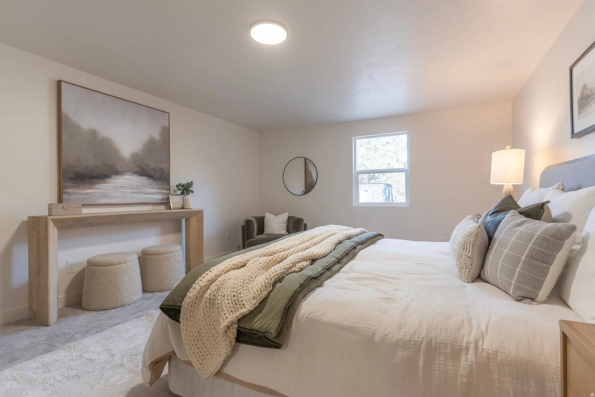 Neutral color palette with recessed lighting and a single window