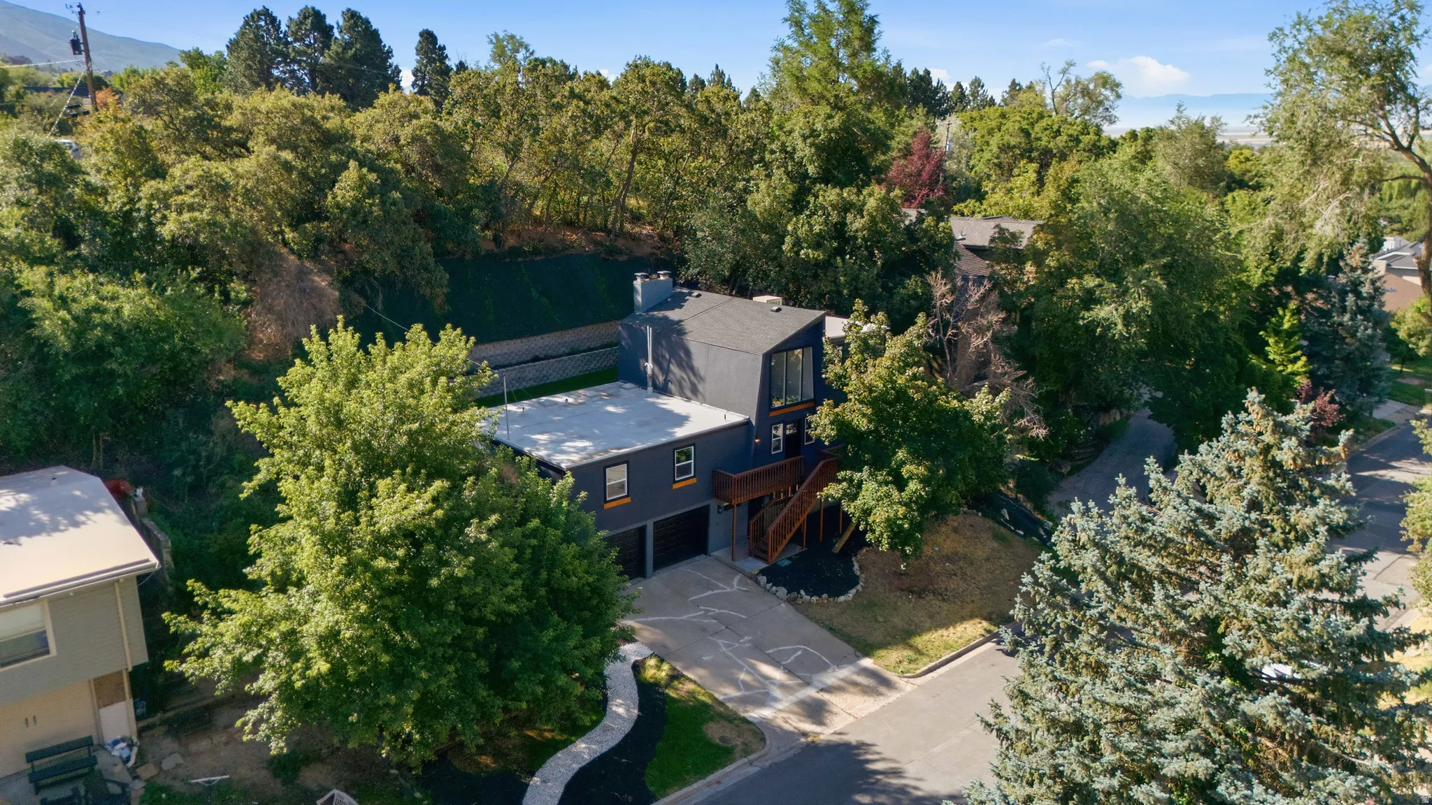 Modern exterior with a dark facade and contrasting wood accents