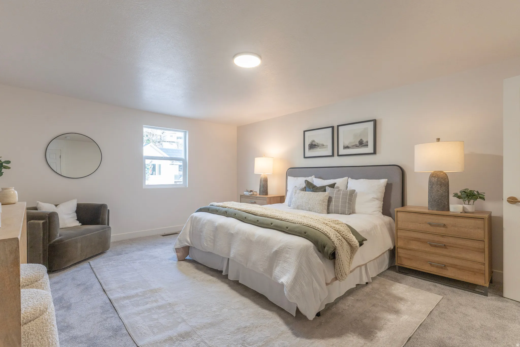 Recessed ceiling lighting, light neutral wall paint, window with white trim, light grey carpeting, and a light wood-finish dresser