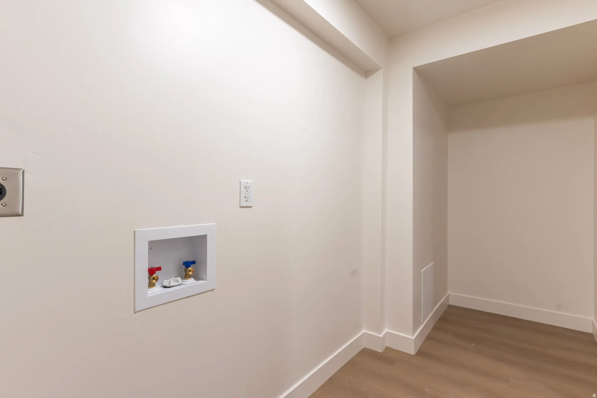 Appliance hookups, wood-finish flooring, and crisp white walls
