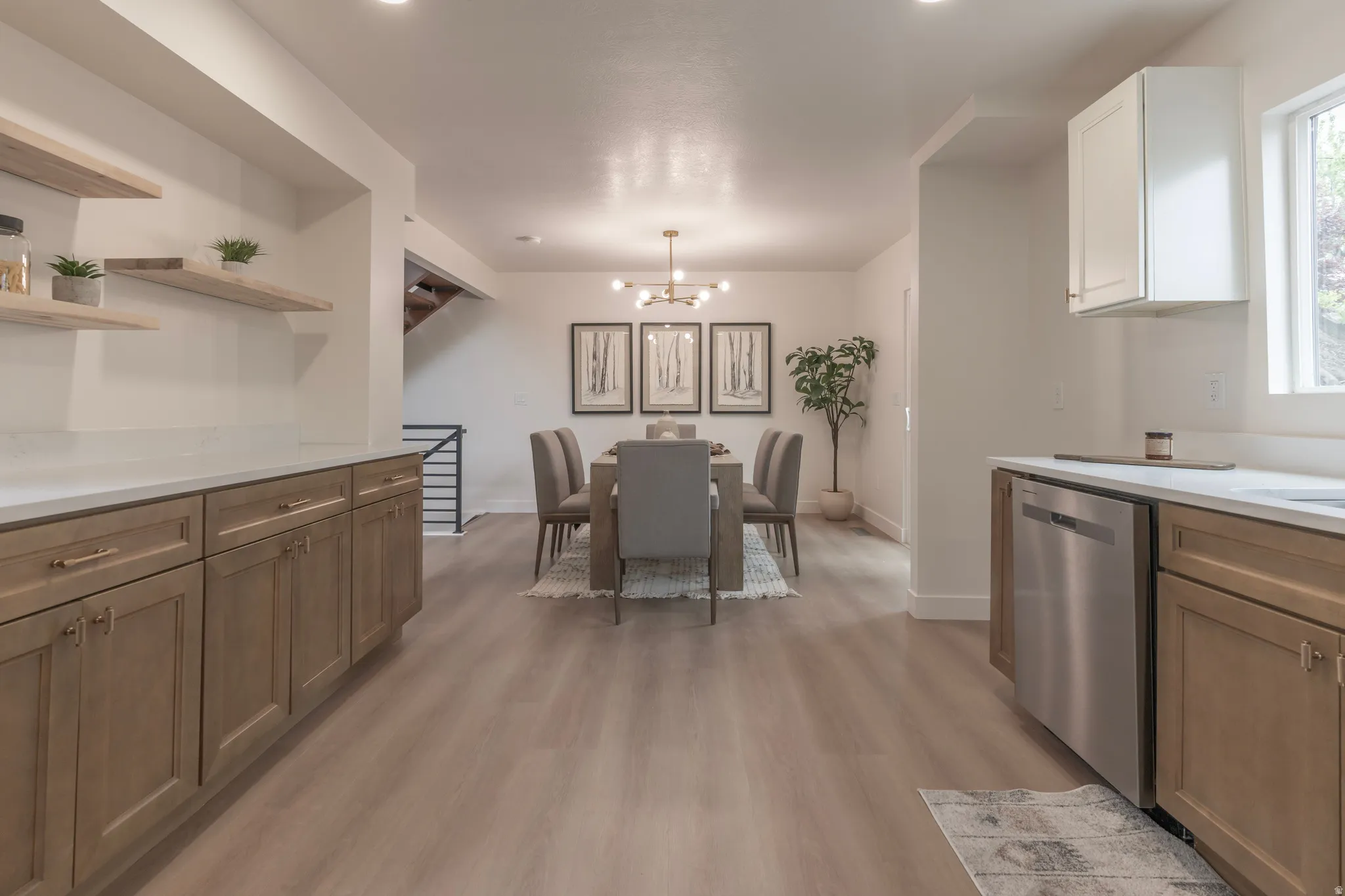 Built-in cabinetry with wood-finish doors, open shelving, and light-toned countertops