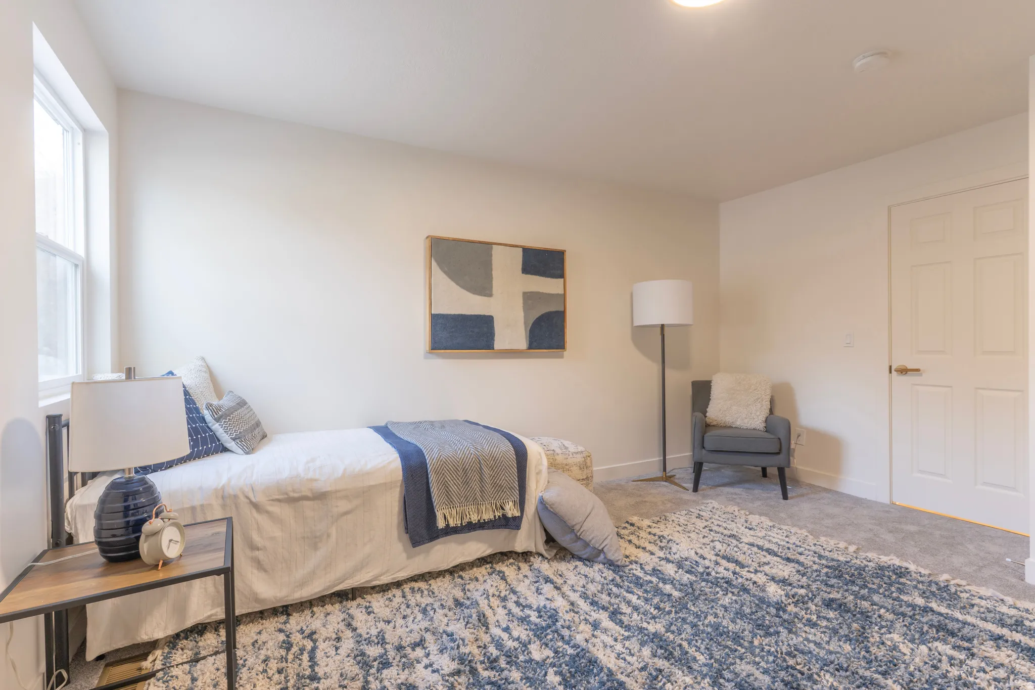 Recessed lighting, light-toned wall paint, white trim, and a paneled interior door