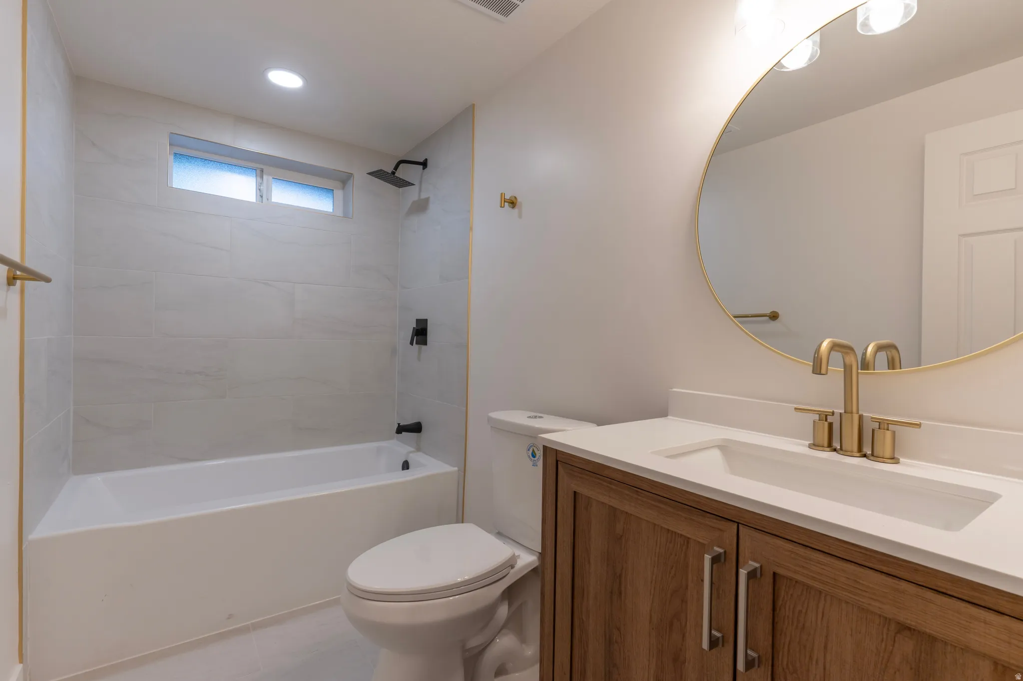 Wood-finish vanity with a white countertop and undermount sink