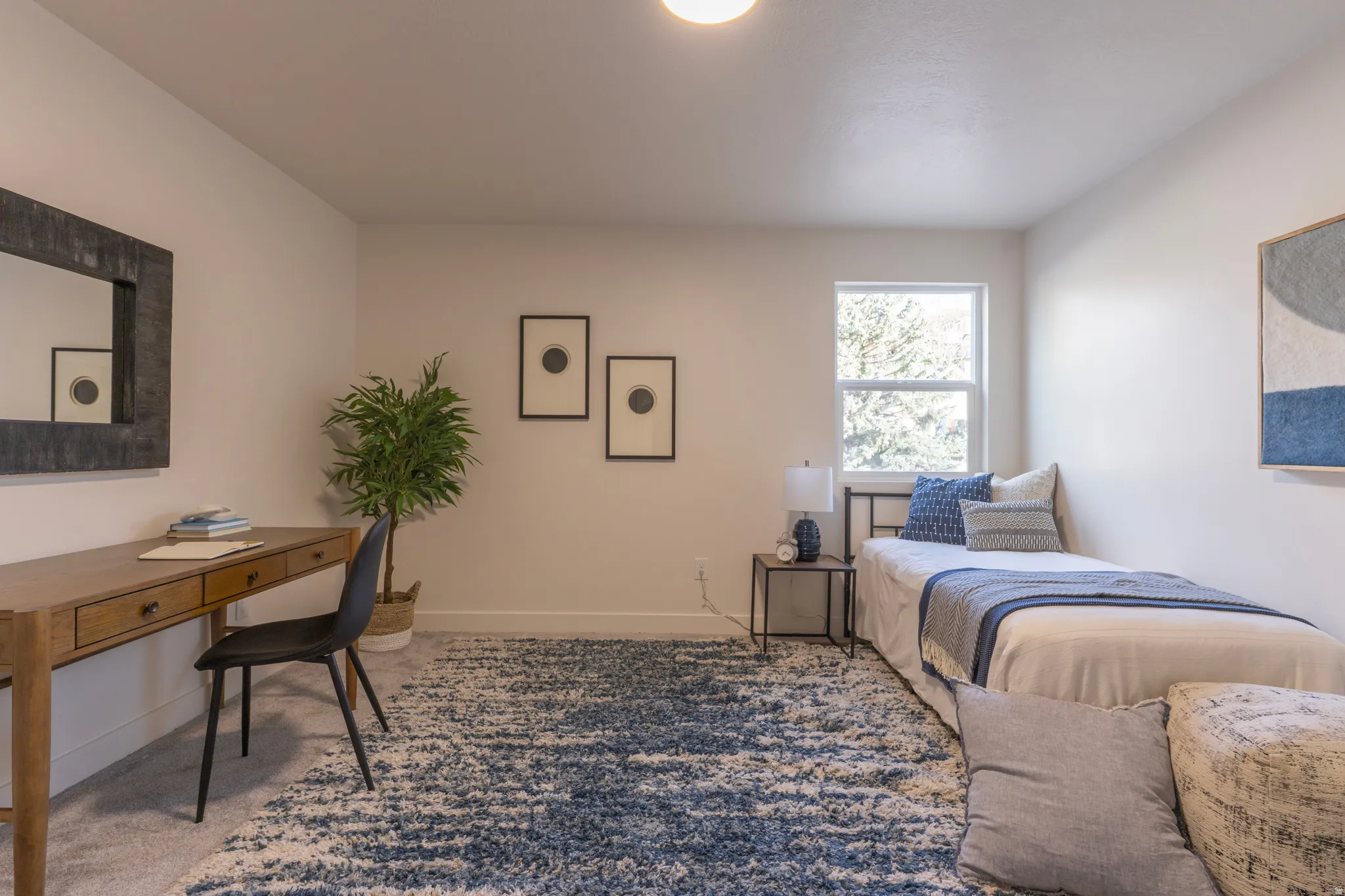 Recessed ceiling lighting, a single window, and light-toned walls