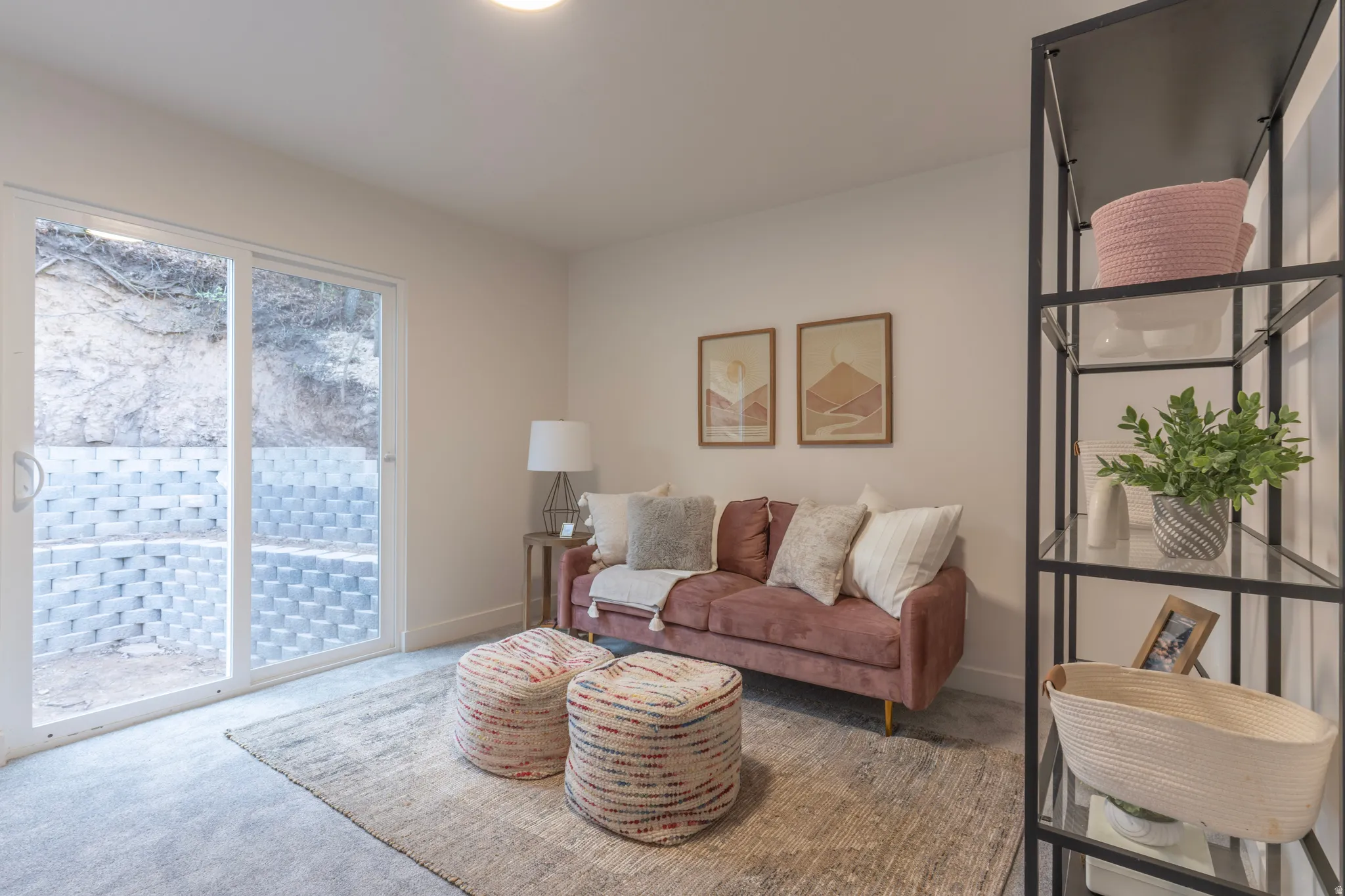 Recessed lighting, light gray carpet, and a white sliding glass door