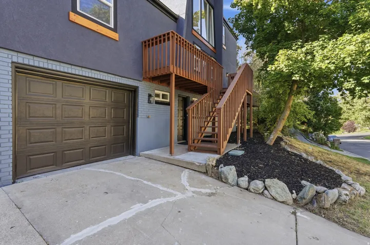 Concrete driveway with a paneled garage door