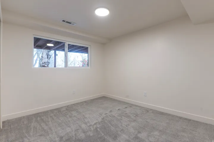 Windowed room featuring wall-to-wall carpeting and recessed ceiling lighting