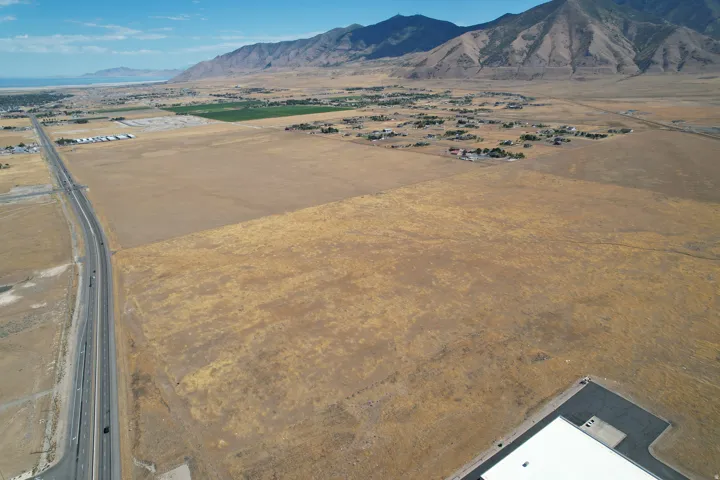Expansive acreage with substantial dry land, bordered by a multi-lane highway