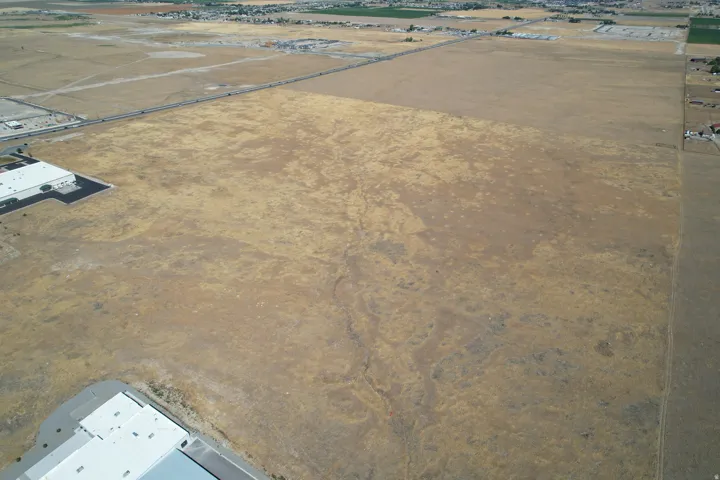 Expansive land parcel with visible road access
