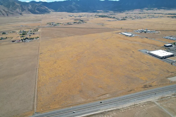 Expansive undeveloped land, mountainous terrain, and a visible roadway