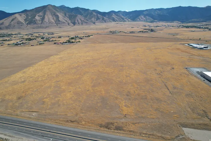 Expansive undeveloped land featuring a clear, flat topography and distant mountain backdrop