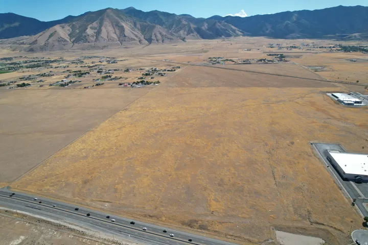 Expansive land parcel featuring direct road frontage and distant mountain scenery