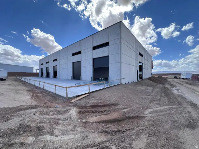 Concrete block construction featuring multiple overhead doors and a concrete loading dock