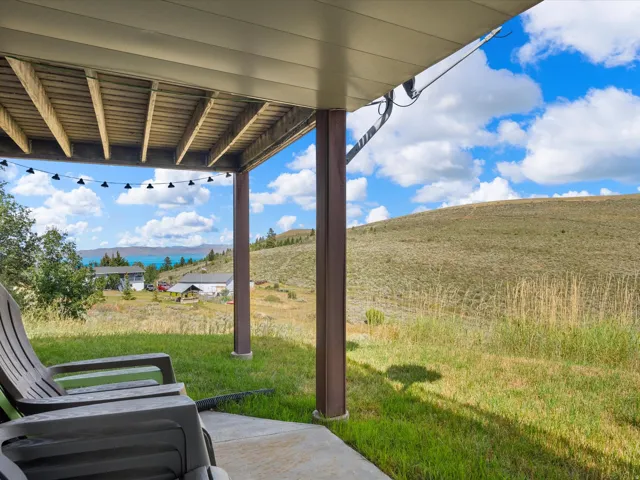 Covered patio space with concrete flooring, supported by structural columns