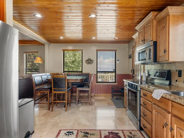 Kitchen featuring wood-finish ceiling, recessed lighting, and tile flooring