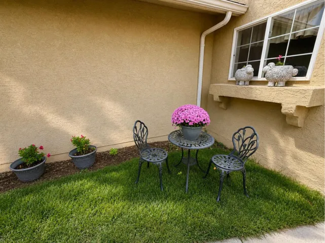 Exterior stucco finish, decorative window ledge, white frame window, and a downspout
