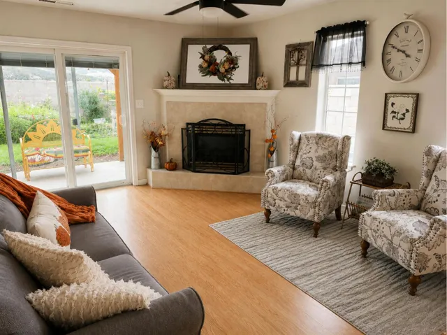 Recessed lighting, wood-finish flooring, ceiling fan, fireplace with hearth, and sliding glass door