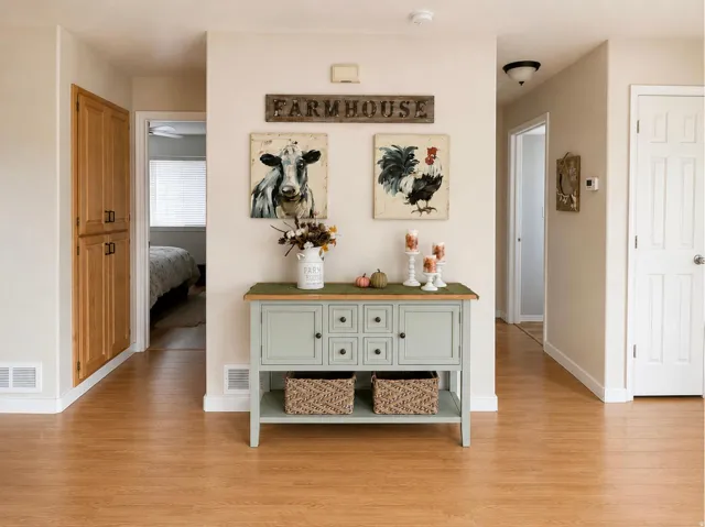Wood-finish flooring throughout, featuring a built-in wood cabinet with black hardware