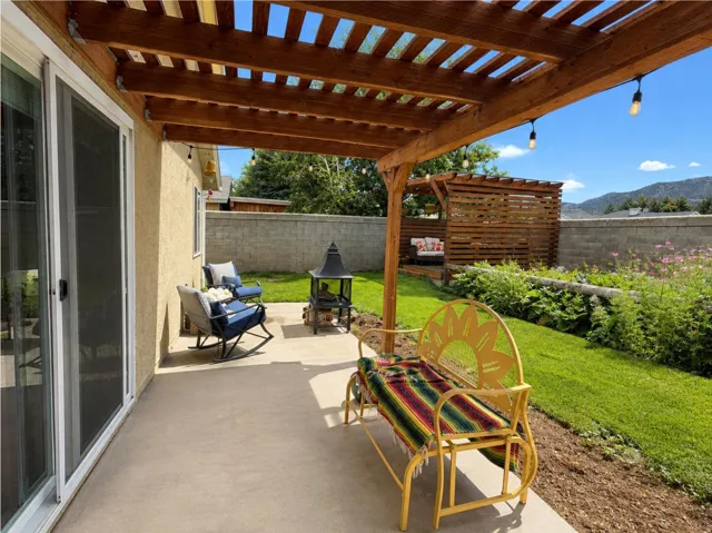 Patio featuring a wood pergola and string lighting