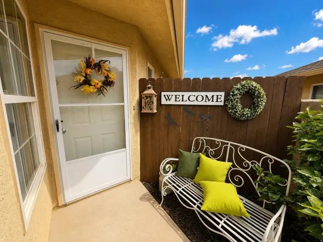 Front entry featuring stucco exterior and a white storm door