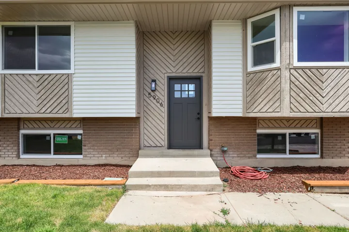 Contemporary exterior featuring horizontal siding, brickwork, and decorative wood panels