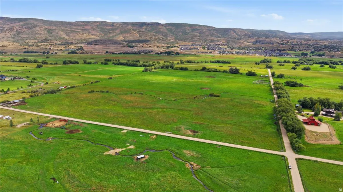 Expansive green acreage with distant mountain backdrop