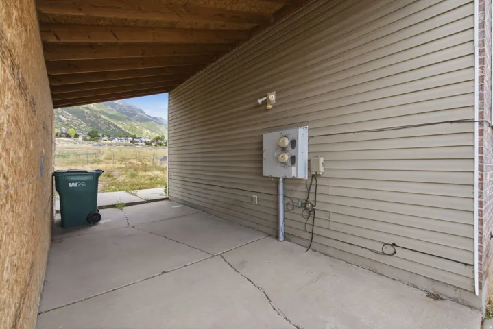 Concrete patio with an exposed wood ceiling and mountain backdrop