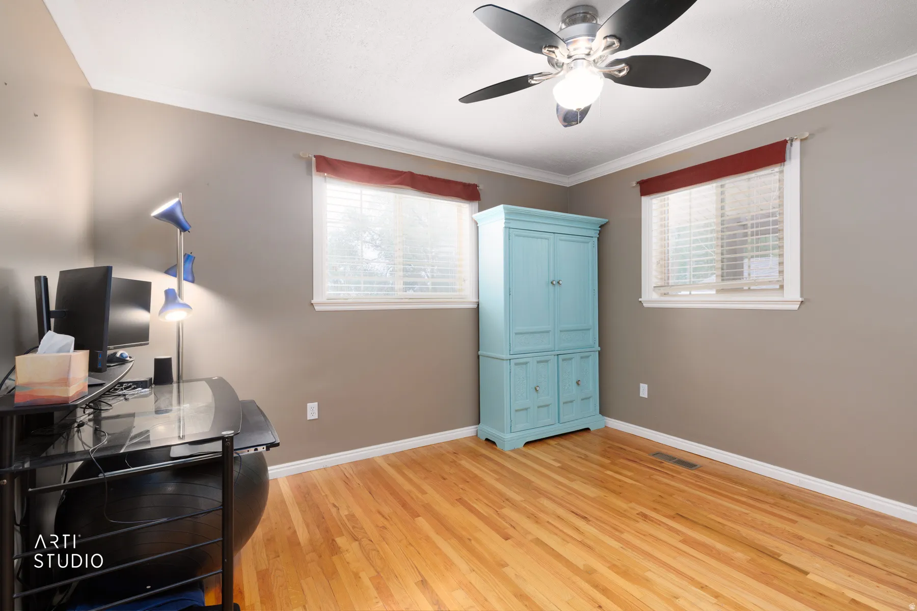Hardwood flooring, crown molding, white trim, and a ceiling fan with integrated lighting