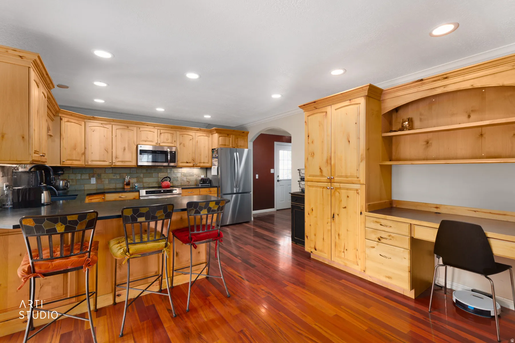 Recessed lighting illuminates the wood-finish flooring