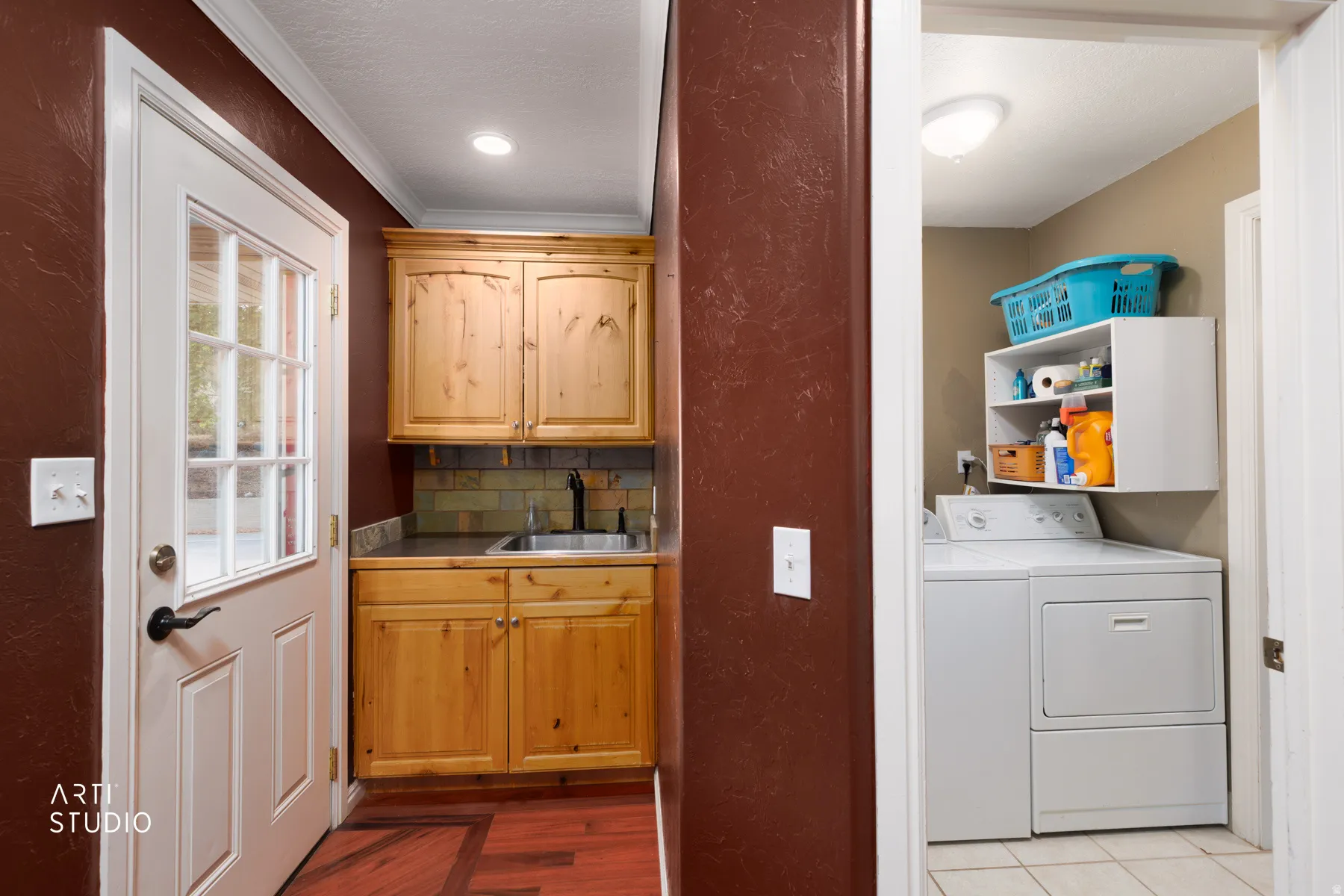 Laundry area with tile flooring and wall-mounted shelving