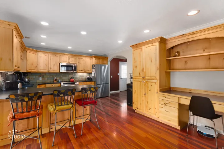 Recessed lighting illuminates the wood-finish flooring
