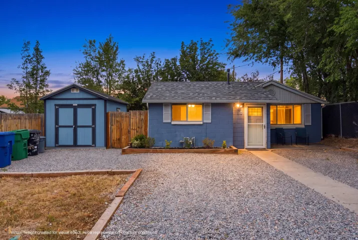 Ranch-style exterior with a gravel driveway, concrete walkway, and a detached shed