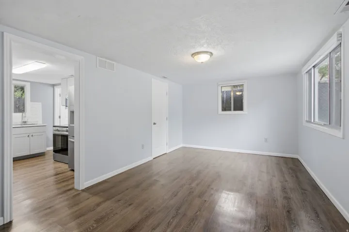 Wood-finish flooring, light-toned walls, and recessed lighting