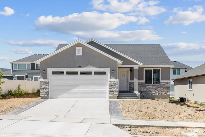Contemporary exterior featuring stucco siding and stone accents