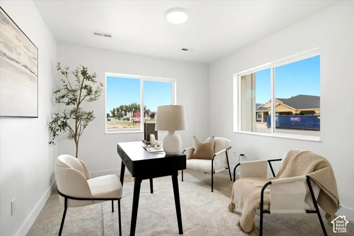 Recessed lighting, large windows, and light-toned walls