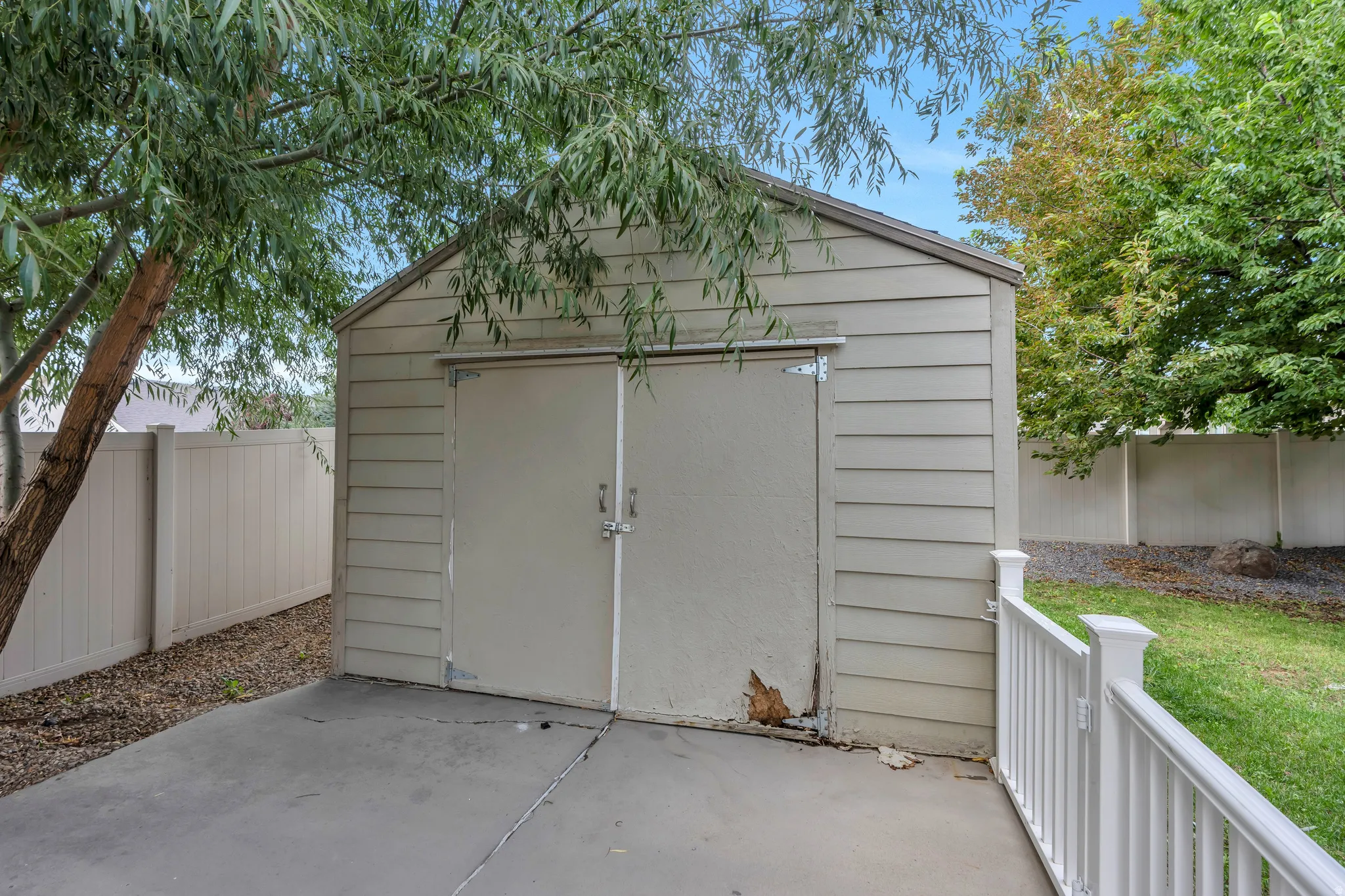 Exterior storage shed with horizontal siding and double doors