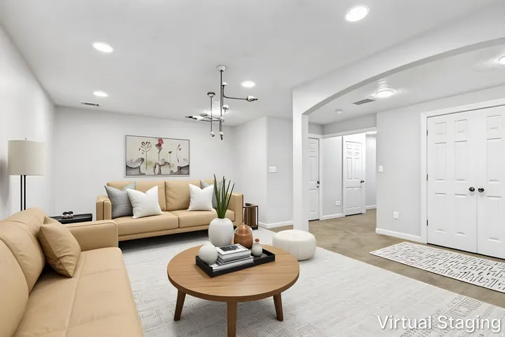 Recessed lighting, contemporary chandelier, arched doorway, paneled interior doors, and carpet flooring