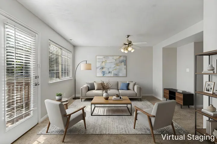 Living area featuring a ceiling fan with integrated lighting, wall-to-wall carpeting, and a window with blinds