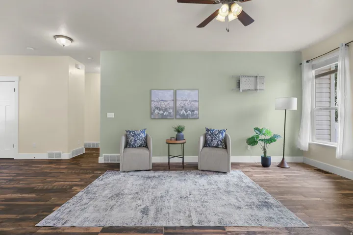 Wood-finish flooring, ceiling fan with integrated lighting, recessed lighting, and a white-framed window